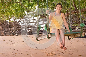 Woman in beach swing