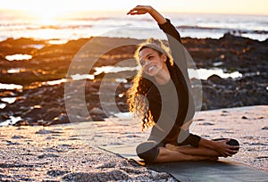 Woman, beach yoga and sunset with smile, stretching and peace of mind in summer sunshine on sand. Girl, zen meditation