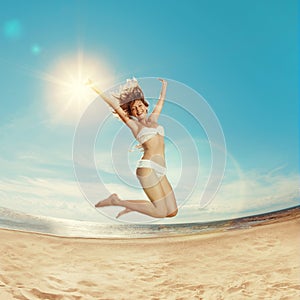 Woman on the beach. Young girl on the sand by sea. Stylish beaut