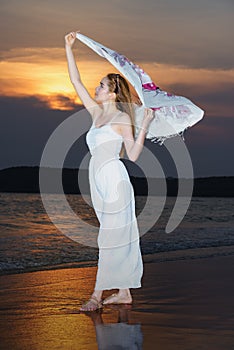 Woman on the beach,Young slim beautiful woman on sunset beach