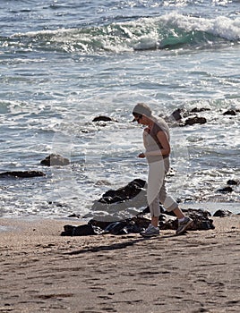 Woman beachcomb on Glass Beach