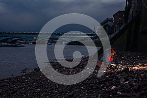 Woman beachcombing in city at night