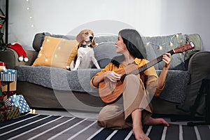 Woman with beagle puppy at living room