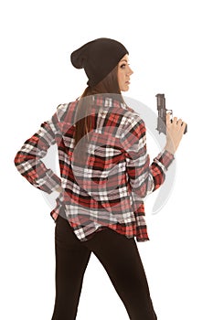 Woman in beanie and plaid shirt gun up side