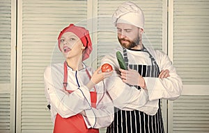 Woman and bearded man cooking together. Chefs of organic food restaurant. Cooking healthy food. Fresh vegetarian healthy