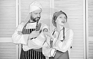 Woman and bearded man cooking together. Chefs of organic food restaurant. Cooking healthy food. Fresh vegetarian healthy