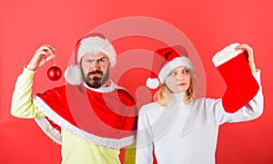 Woman and bearded man in santa hat waiting christmas red background. Christmas stocking tradition. Couple christmas