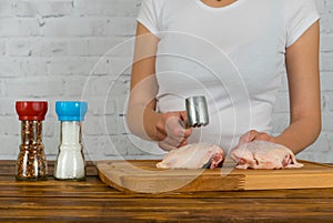 Woman beats chicken with a hammer