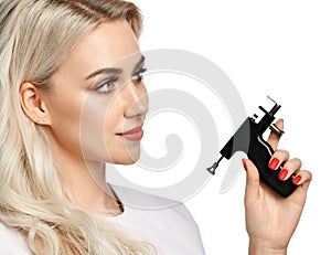 Woman beautician cosmetologist hold Ear Piercing Gun looking at the corner isolated on white