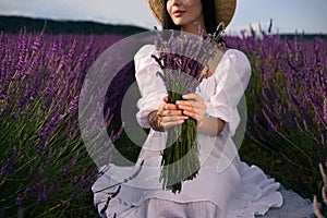 Woman with beautiful bouquet in lavender field, closeup