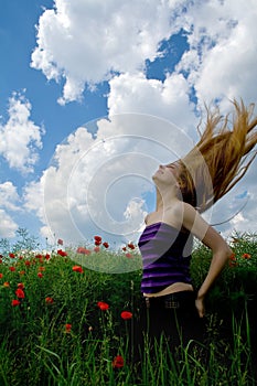 Woman with beautiful hair in splendid green meadow