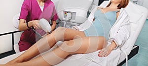 Woman with beautiful legs gets laser epilation treatment at beauty clinic