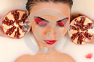 Woman with beautiful make-up with pomegranates