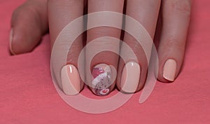 Woman with beautiful manicured red fingernails gracefully crossing her hands to display them to the viewer on a white background