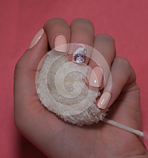 Woman with beautiful manicured red fingernails gracefully crossing her hands to display them to the viewer on a white background