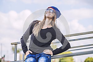 Woman beautiful model in hat and sunglasses in the city