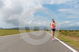 Woman in the beautiful scenery road street jogging