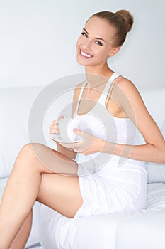 Woman with beautiful smile drinking coffee