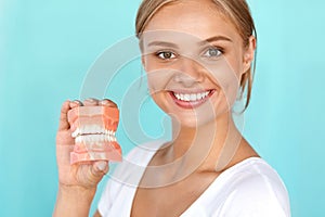 Woman With Beautiful Smile, Healthy Teeth Holding Dental Model