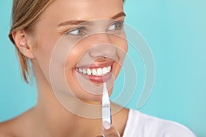 Woman With Beautiful Smile, Healthy Teeth Using Whitening Pen