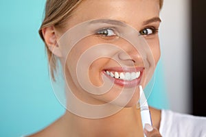 Woman With Beautiful Smile, Healthy Teeth Using Whitening Pen