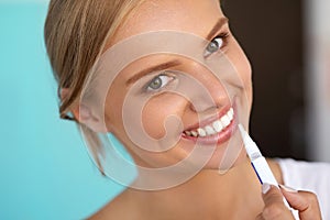 Woman With Beautiful Smile, Healthy Teeth Using Whitening Pen