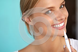 Woman With Beautiful Smile, Healthy Teeth Using Whitening Pen