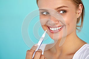 Woman With Beautiful Smile, Healthy Teeth Using Whitening Pen