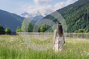 woman with beautiful snow mountain and green hill landscaped, in the morning