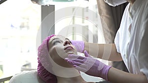Woman in beauty clinic. Cosmetologist works with patient in beauty clinic. Skin care and anti aging procedure in