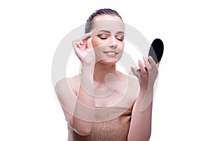 The woman in beauty concept applying make up using cosmetics