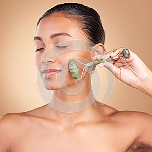 Woman, beauty and derma roller with face, eye closed with facial massage and skincare on studio background. Cosmetic