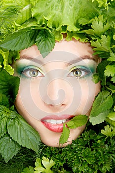 Woman beauty face with greens vegetables frame