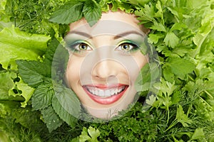 Woman beauty face with greens vegetables frame isolated on white