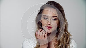 Woman with beauty face makeup touching lips skin