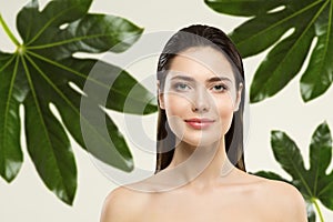 Woman Beauty Face Natural Make up. Green Leaf Cosmetic Skin Care. Wet Hair Perfect Model in Tropical Leaves Nature Background