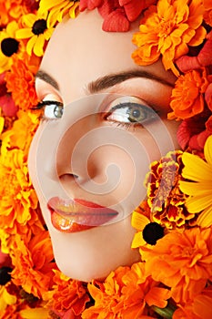 Woman beauty face with orange flowers