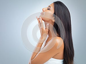 Woman, beauty and hair with cosmetics, profile on model in studio with shine and keratin treatment on grey background