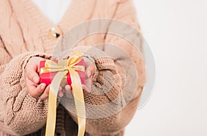 Woman beauty hands holding small gift package box present