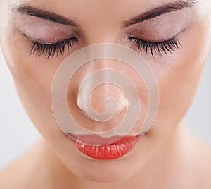 Woman, beauty and makeup in studio for cosmetics, dermatology and eyelash extension on a white background. Closeup, face