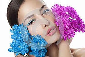 Woman beauty portrait with blue and pink flowers