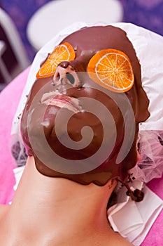 Woman in beauty salon with a chocolate face mask