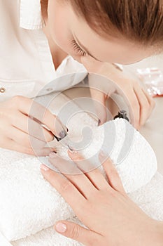 Woman in beauty salon getting manicure done.