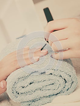 Woman in beauty salon getting manicure done.