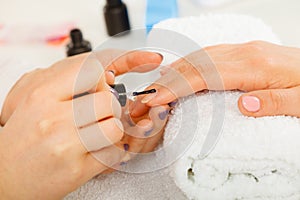 Woman in beauty salon getting manicure done.