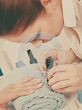 Woman in beauty salon getting manicure done.