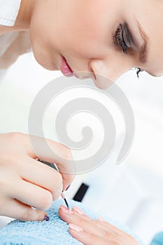 Woman in beauty salon getting manicure done.