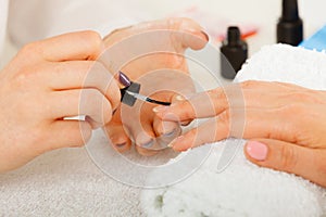 Woman in beauty salon getting manicure done.