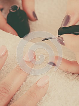 Woman in beauty salon getting manicure done.