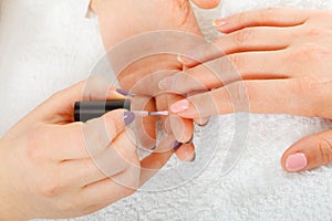 Woman in beauty salon getting manicure done.